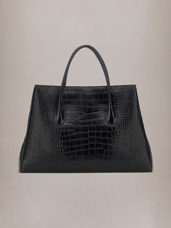 Black tote bag with embossed crocodile texture and dual handles.