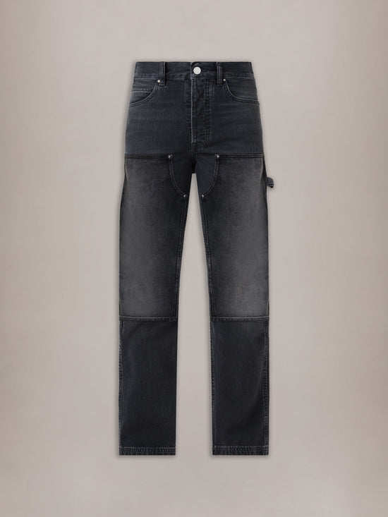 Vintage black carpenter jeans with contrasting panel sections, utility pockets, and white top button.