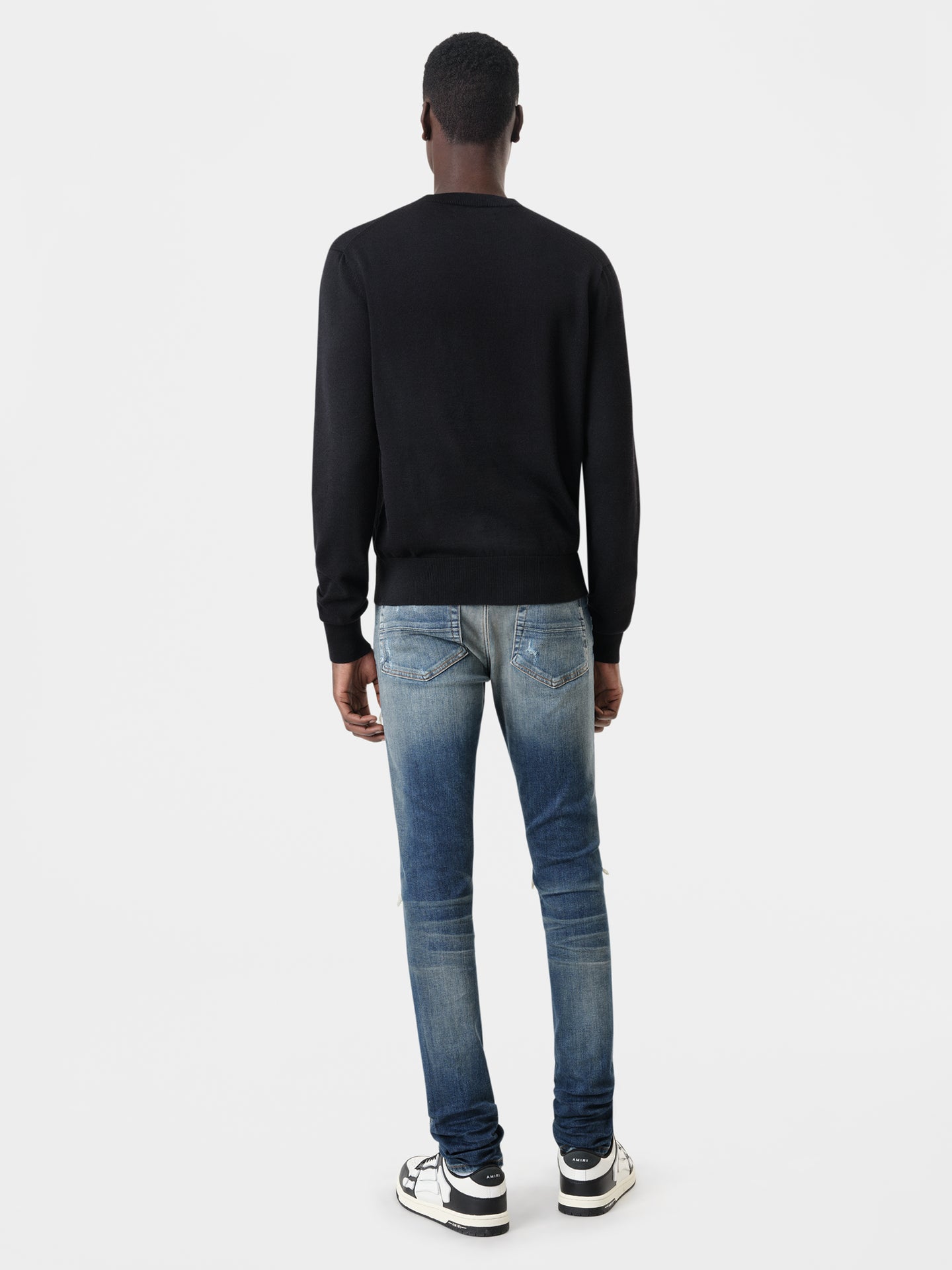 AMIRI MX1 Jean in Deep Classic Indigo with MA Long Sleeve Black Shirt and Black White Skel Top Low Sneakers