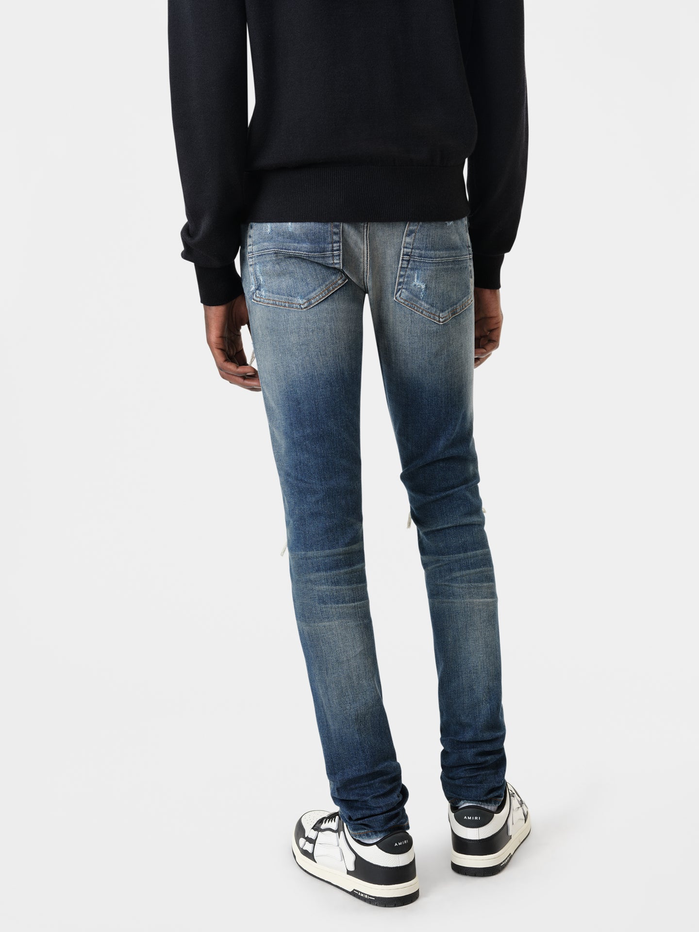 AMIRI MX1 Jean in Deep Classic Indigo with MA Long Sleeve Black Shirt and Black White Skel Top Low Sneakers